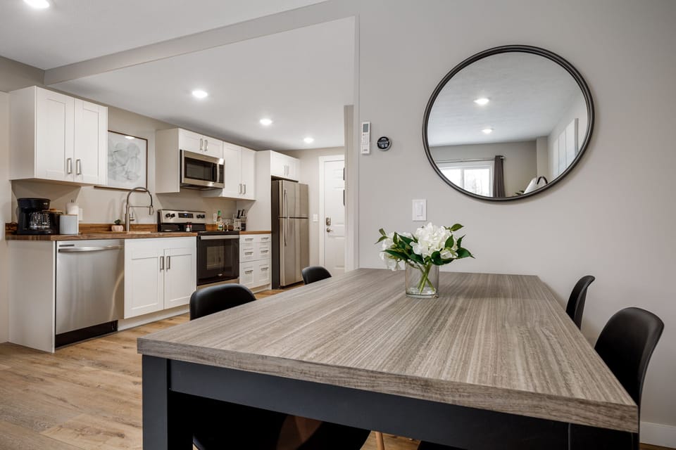 Spacious dining table set beside the kitchen, perfect for shared meals & game nights.