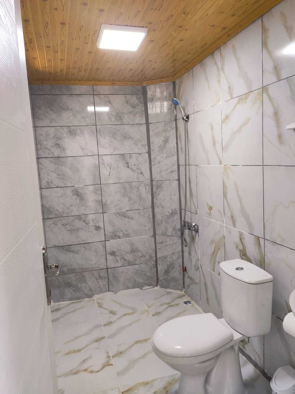 Shower, rainfall showerhead, hair dryer, towels