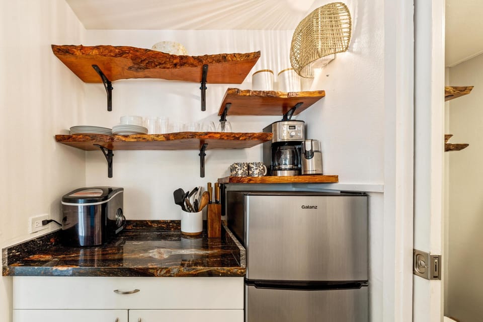 Your kitchenette features rustic live-edge shelving, a coffee maker, mini fridge, and all the essentials for preparing light meals and morning coffee in cozy style.