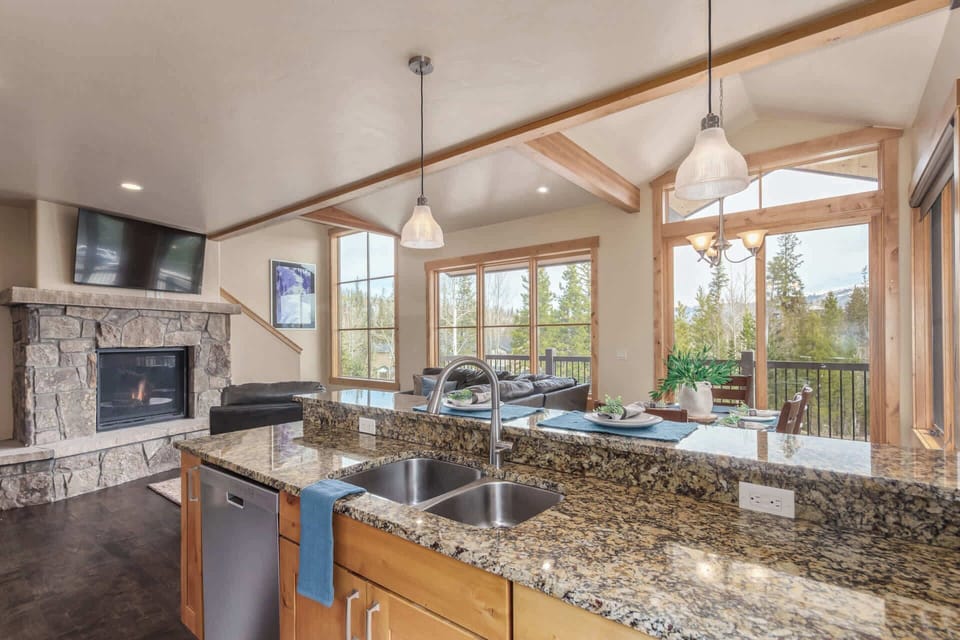 This charming kitchen boasts stainless steel appliances, a convenient bar/serving area with seating for four that connects to the dining room space and access to a patio.