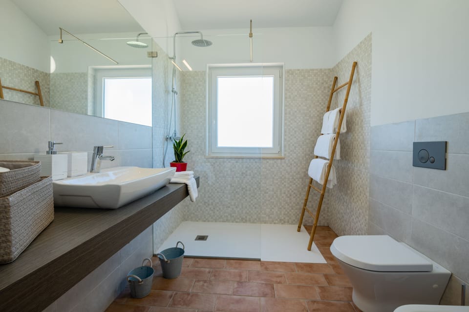 Deluxe Room, Pool View | Bathroom | Shower, rainfall showerhead, hair dryer, children's robes
