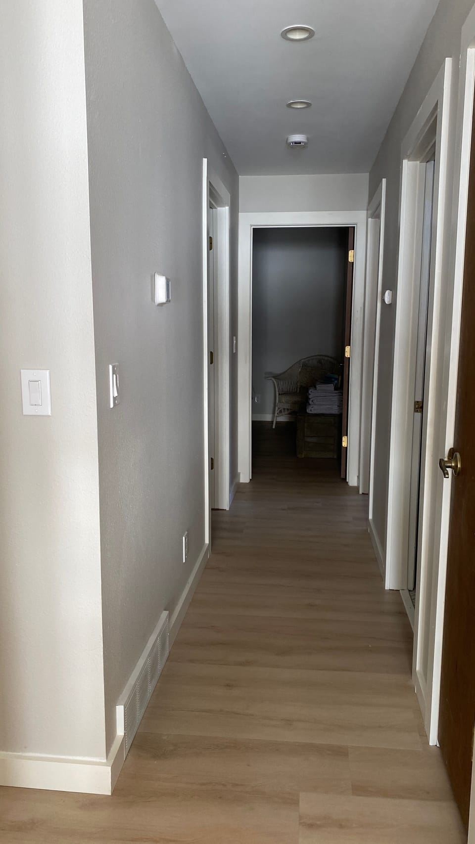 The hallway on the main floor brings you to three bedrooms and 2 bathrooms