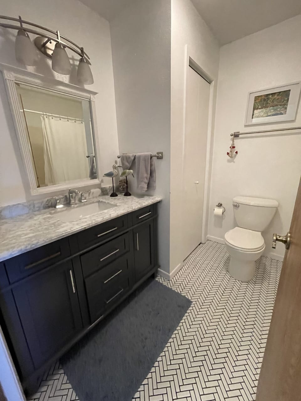 Newly renovated main floor bathroom with combined tub and shower. 