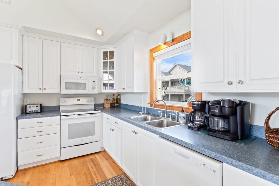 Top-Level Kitchen: Fully equipped kitchen with flat top stove, built-in microwave, dishwasher, and side-by-side refrigerator.