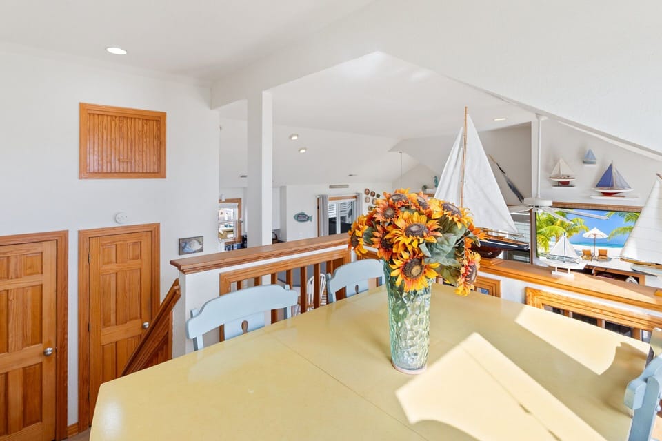 Top-Level Captain's Watch: Lofted seating area with small table and panoramic Corolla views, ideal for games or quiet reading.
