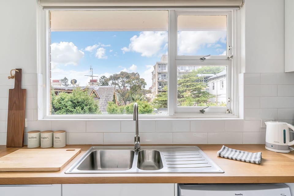Light bright kitchen with a green outlook.