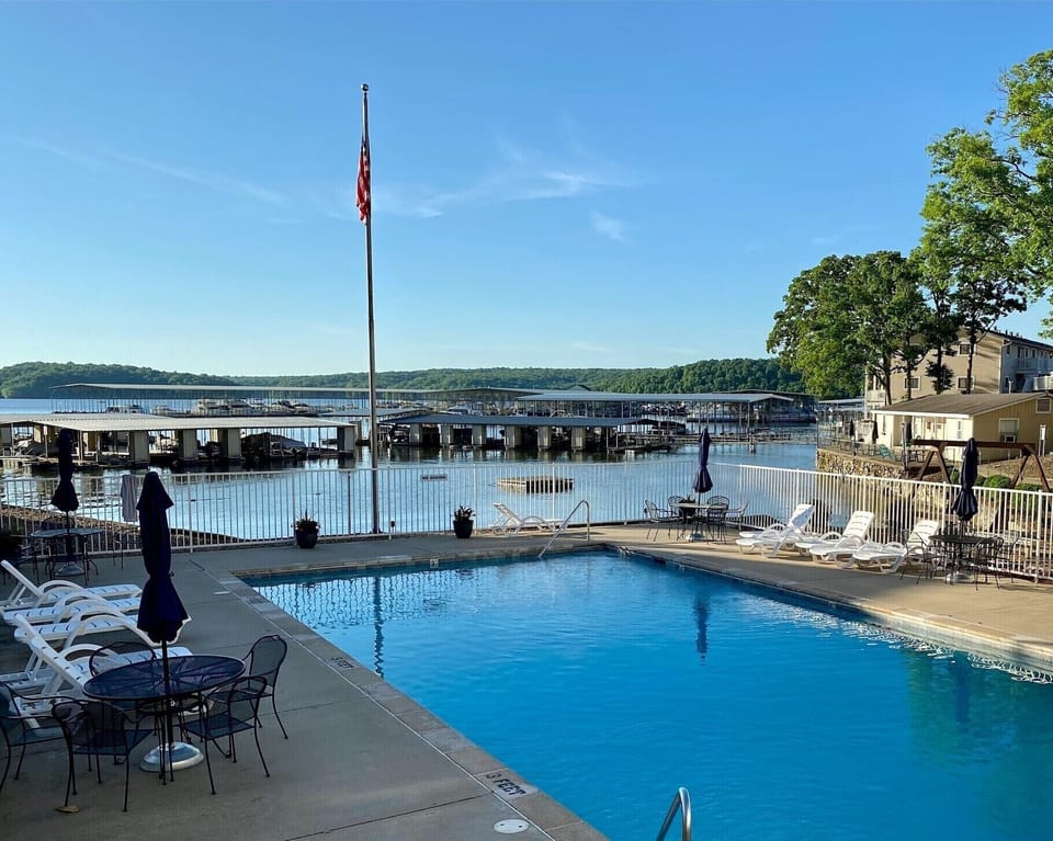 Large heated pool with view of lake and plenty of seating