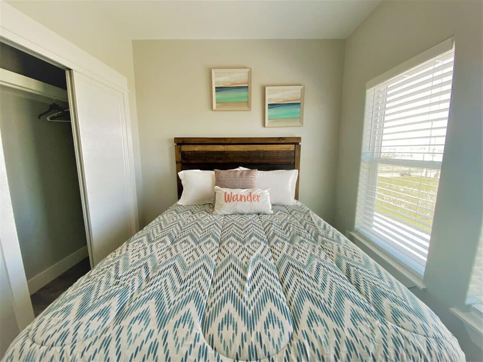 Sleep in style — this cheerful bedroom features bright natural light and beach-inspired bedding for ultimate relaxation.