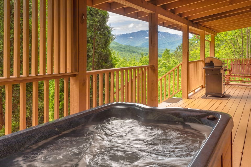 Relax outside on the hot tub and enjoy incredible mountain views.