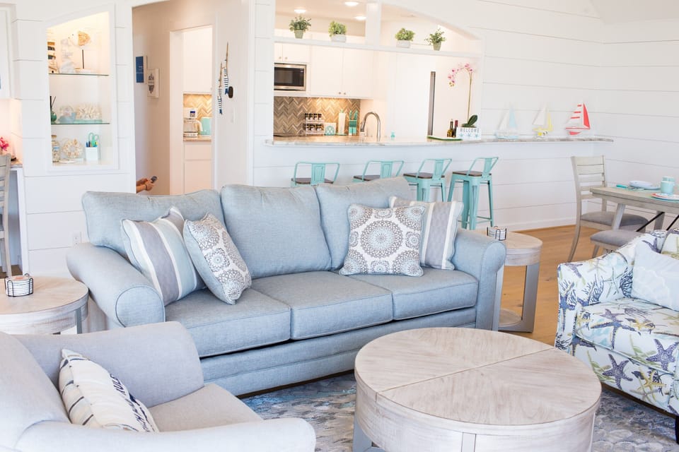 Living room with coastal theme decore and plenty of seats for the entire family.