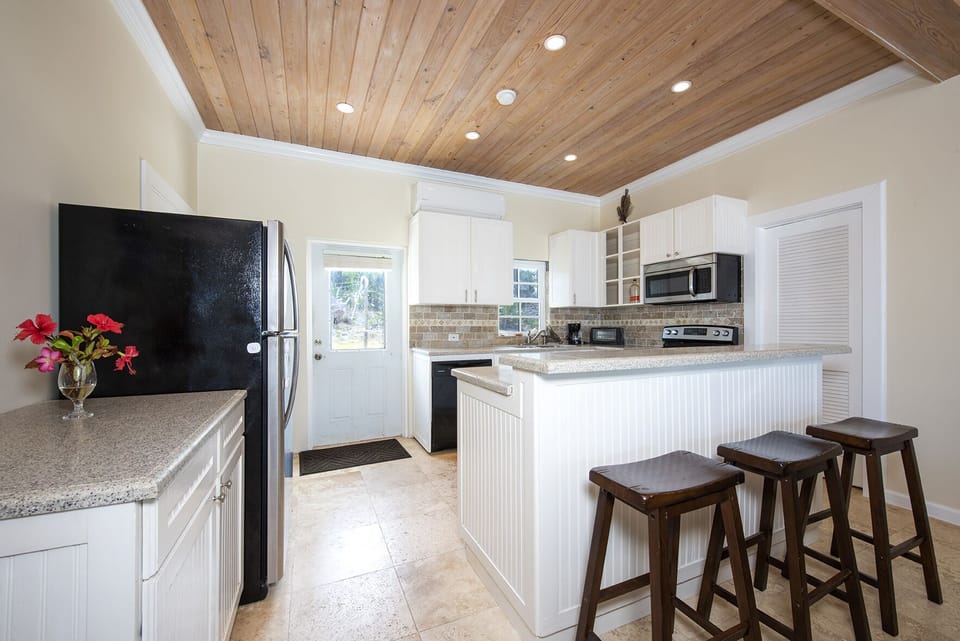 The villa's modern ocean-view kitchen is finished in Corian and stainless steel and fully equipped with full-size refrigerator/freezer, range, oven, dishwasher, microwave, blender, toaster oven, cake mixer, and more.