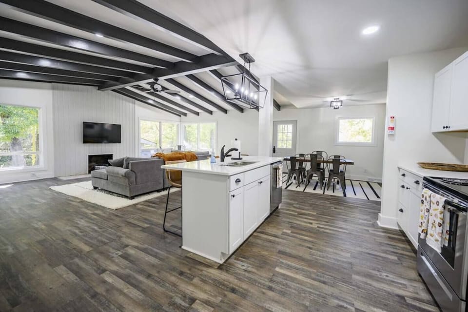 Natural light floods in through large windows, casting a soft glow over the tastefully curated décor that seamlessly blends rustic elements with modern comforts. 