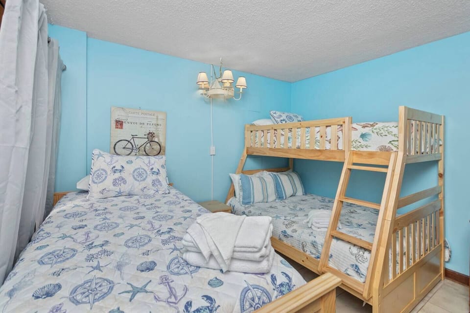 Second bedroom w/ 3 twin beds and 1 full