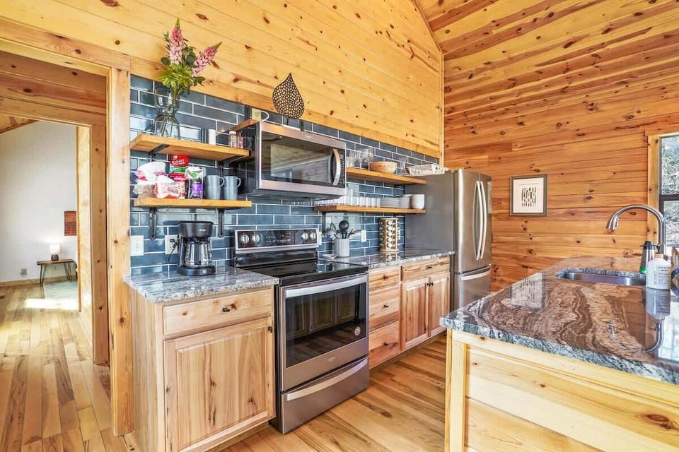 Kitchen: Sleek appliances meet rustic charm, perfect for culinary adventures or morning coffee!