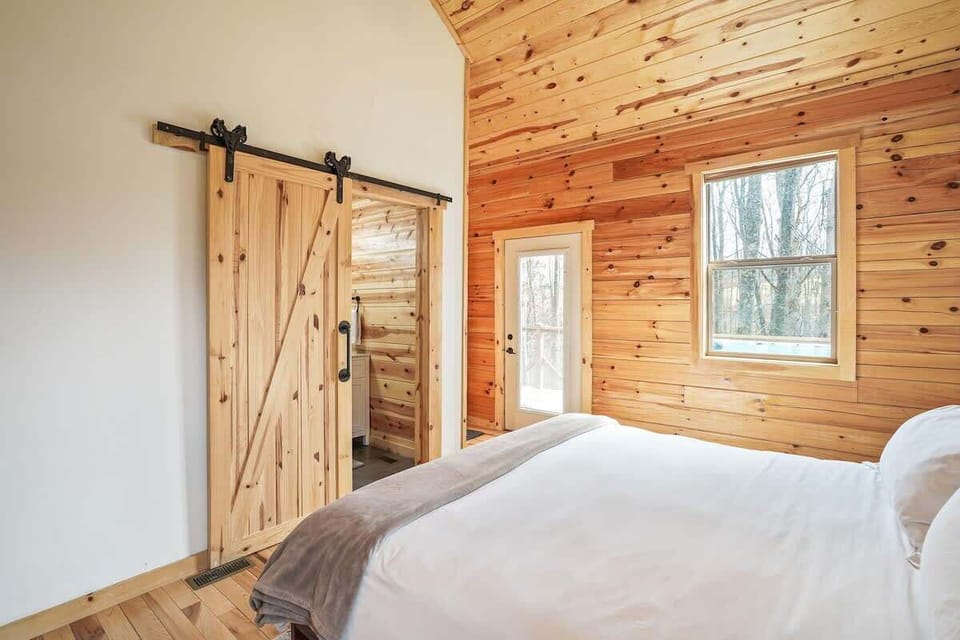 Bedroom Oasis: Experience rustic charm with natural wood accents and serene forest views!