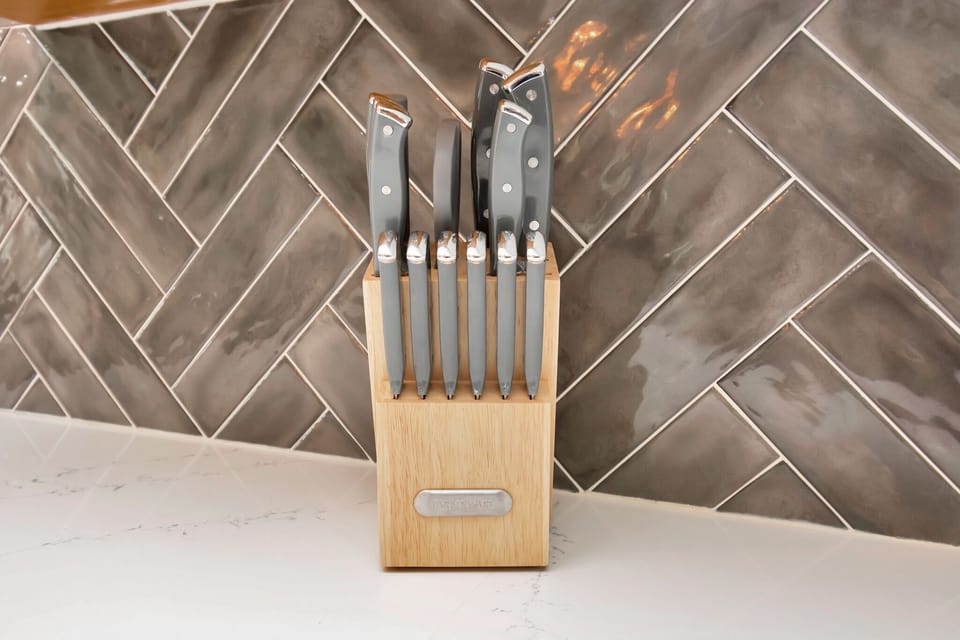 Kitchen is fully stocked with utensils including knives and silverware.