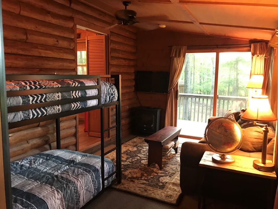 Bunk room with queen size sleeper sofa, 2 new bunk beds and a smart TV.