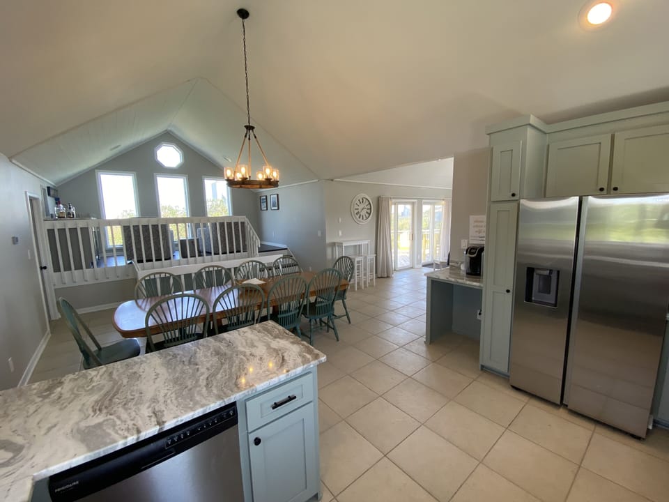 Kitchen with loft in background.