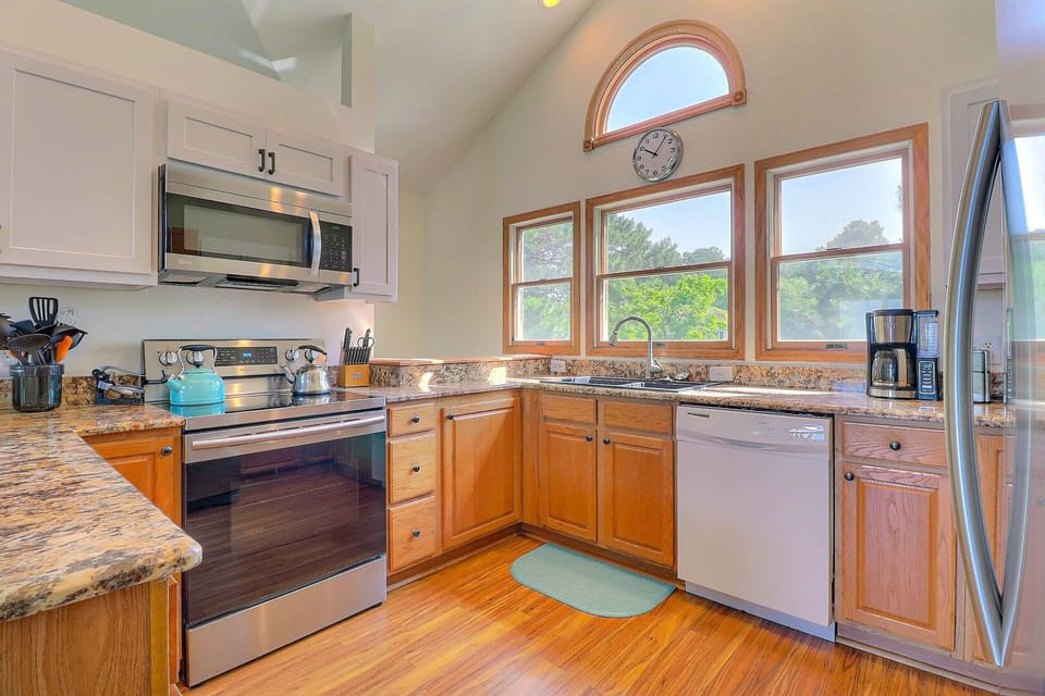 The Kitchen features a breakfast bar, granite countertops, and stainless steel appliances.