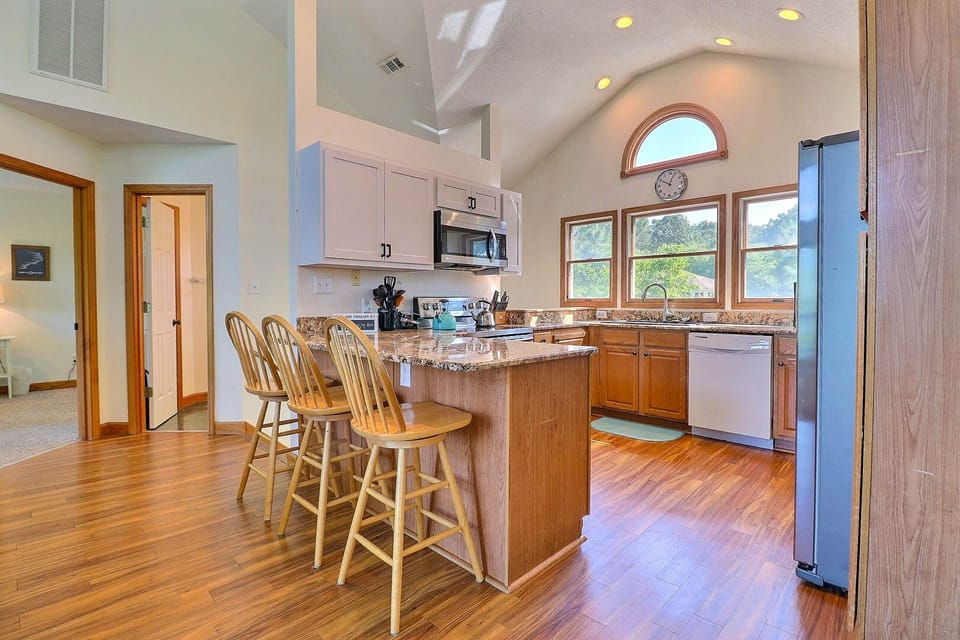 The Kitchen features a breakfast bar, granite countertops, and stainless steel appliances.