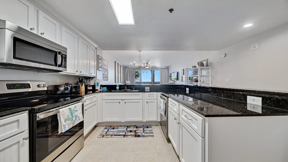 A tidy and functional kitchen countertop. This organized space, complete with coffee makers, a toaster, and a paper towel holder, makes everyday tasks a breeze.