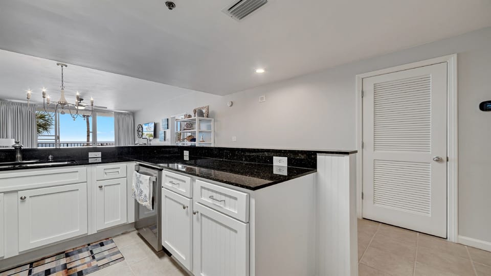 Clean lines and modern finishes define this well-appointed kitchen, offering a sleek and stylish cooking environment with views.