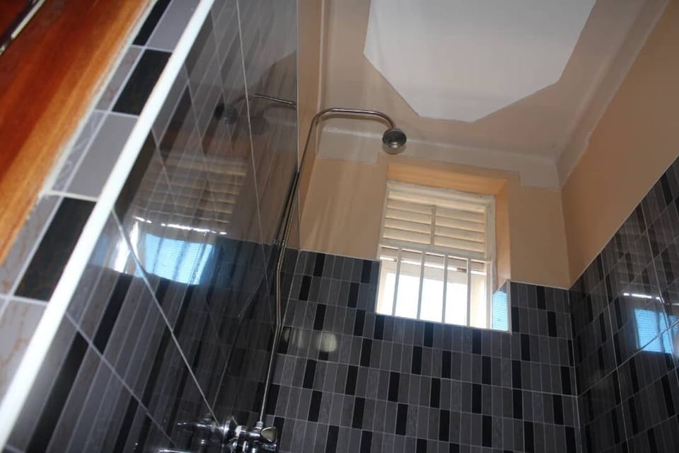 Shower, rainfall showerhead, slippers, towels