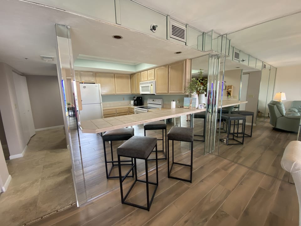 Open kitchen with breakfast bar and two additional seats.