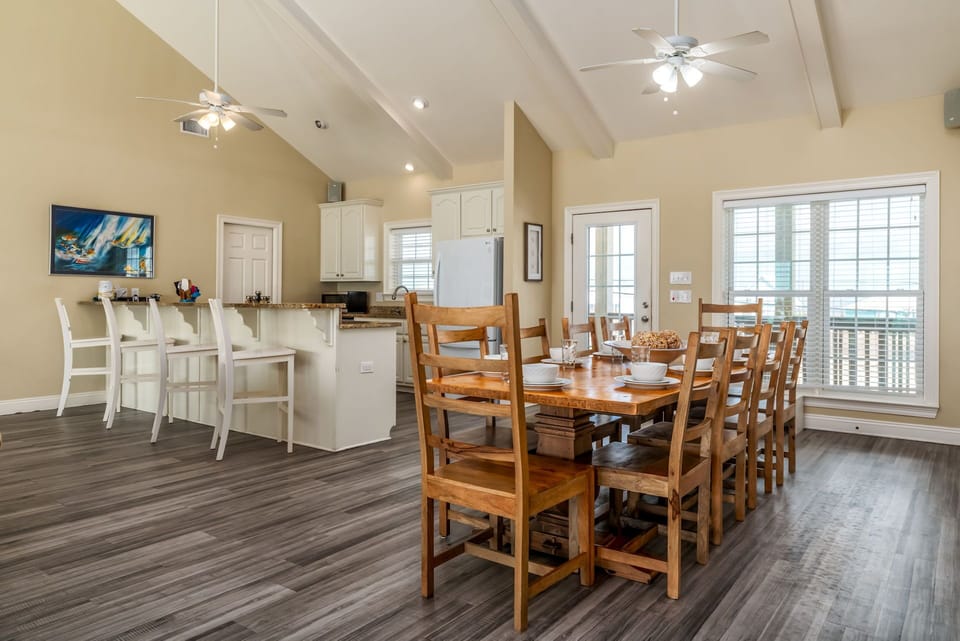Gather around this spacious dining table for memorable meals, with your fully equipped kitchen and bright living space creating the perfect backdrop for relaxation.
