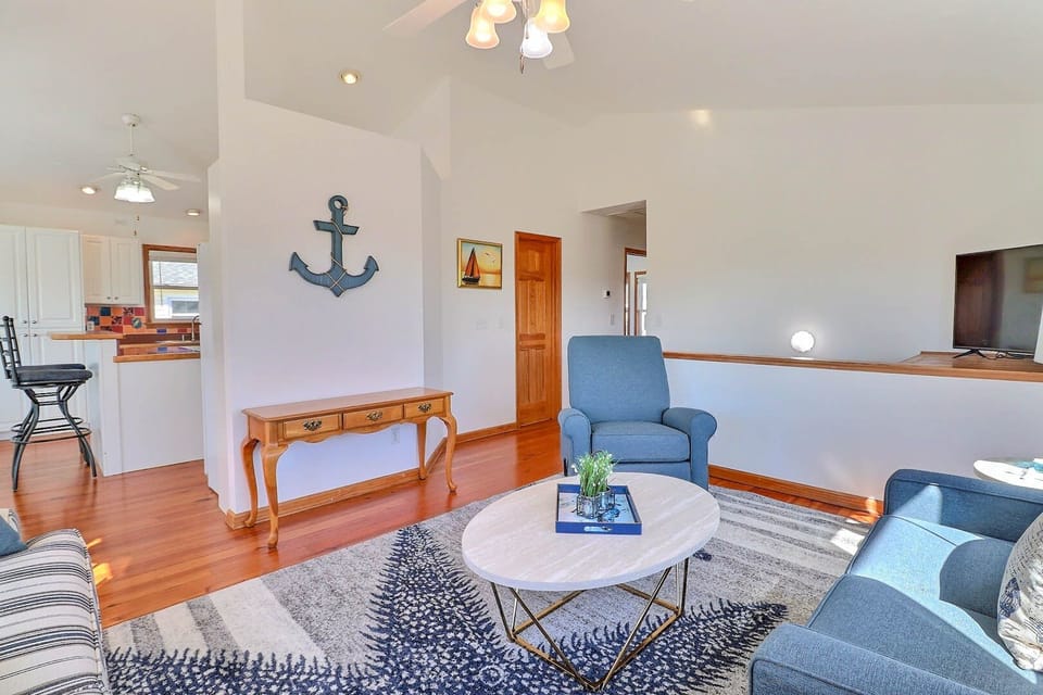 Upstairs, you'll enjoy spending time with the family in the thoughtfully decorated living area with coastal accents!