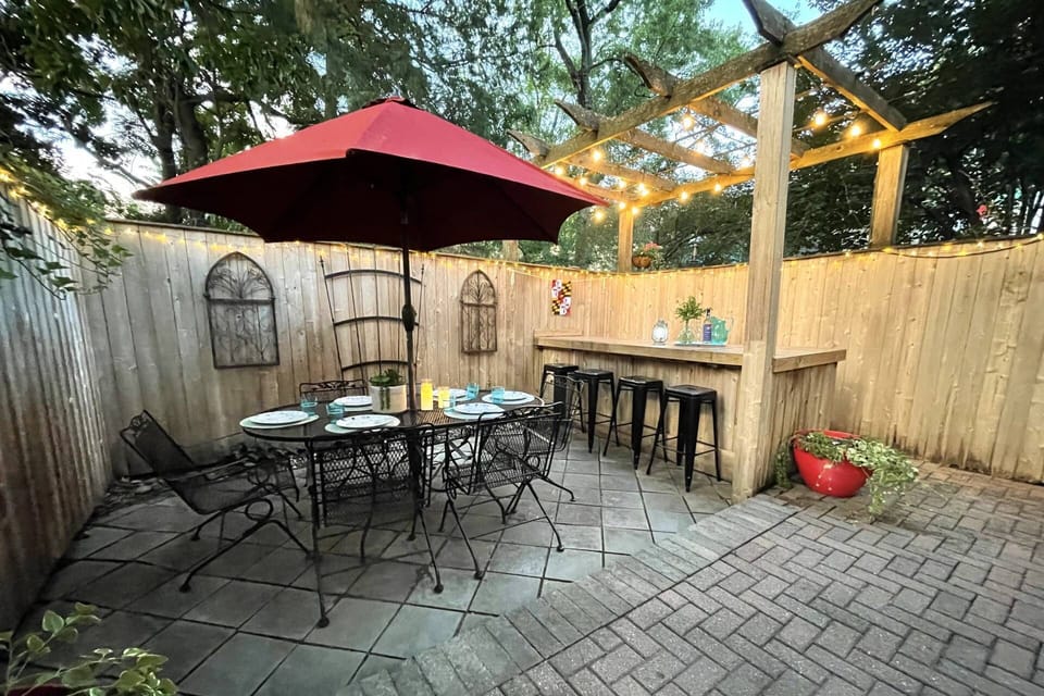 The private back patio is complete with a bar, dining table and BBQ grill.