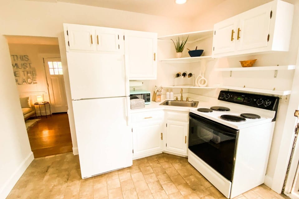The kitchen is stocked with all the pots, pans and utensils needed to cook a full meal.