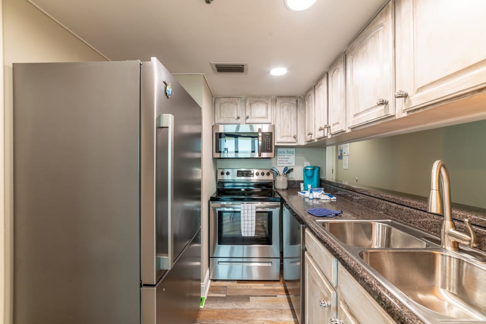 This kitchen is fully stocked and provides a keurig coffee maker