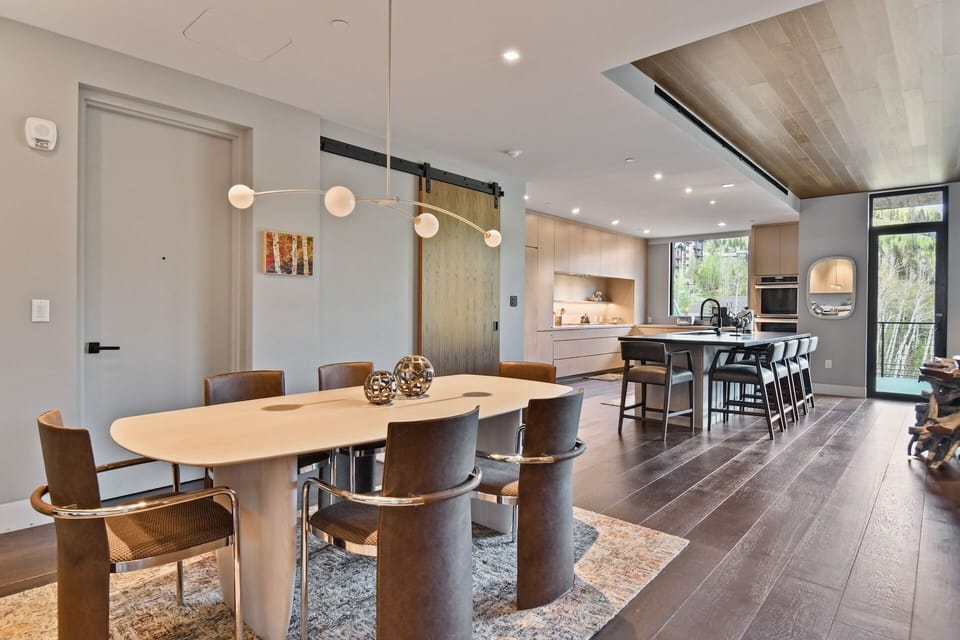 Gather around this inviting dining and kitchen space, where modern design meets warmth. The open layout with natural light and sleek finishes creates your perfect setting for shared meals and memories.