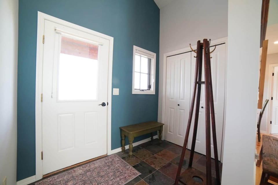 Kick your shoes off or stash your bags in the entryway — the closet also holds a terrific foldaway bed.