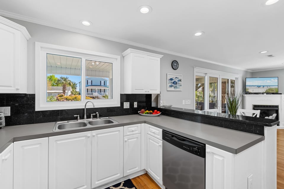 Cook with confidence in your bright, modern kitchen featuring sleek appliances and elegant countertops overlooking charming neighborhood views.