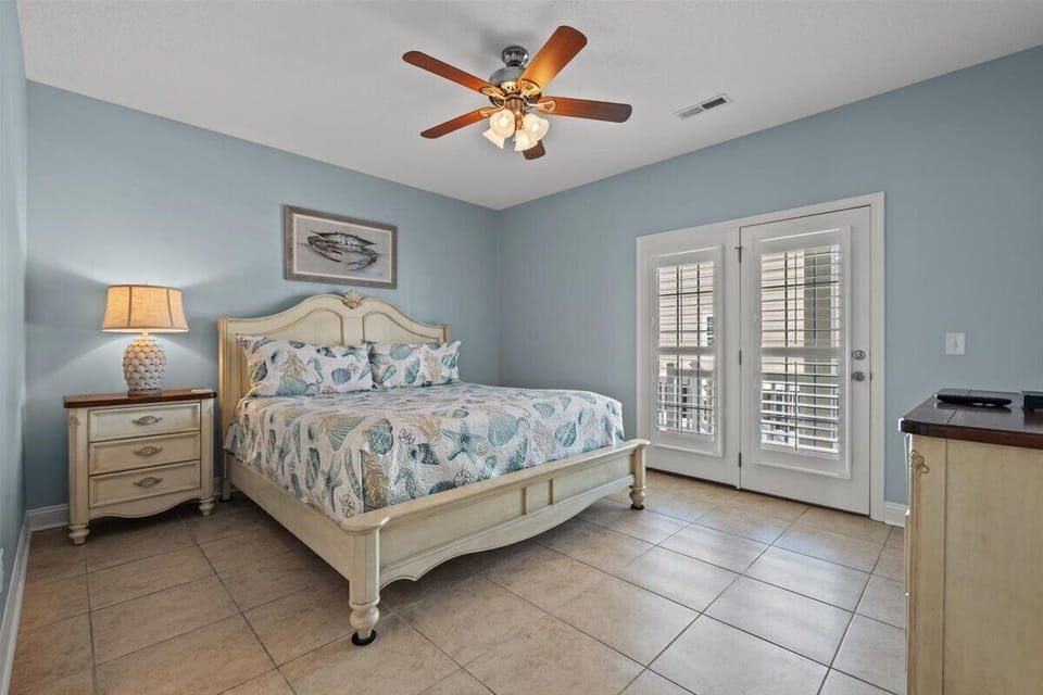 Drift off to peaceful sleep in your coastal-themed bedroom, complete with ocean-inspired linens and French doors opening to your private space.