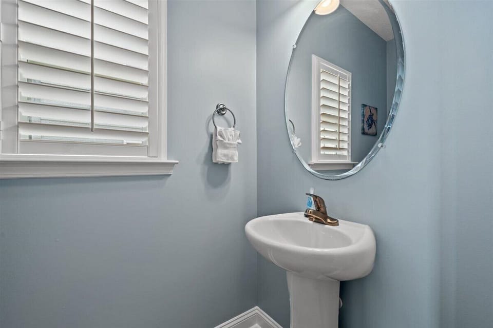 Freshen up in your private powder room with soothing blue walls and crisp white fixtures.