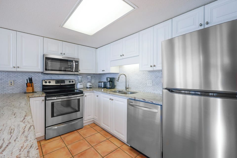 Prepare meals in this stylish kitchen featuring stainless appliances and ample counter space