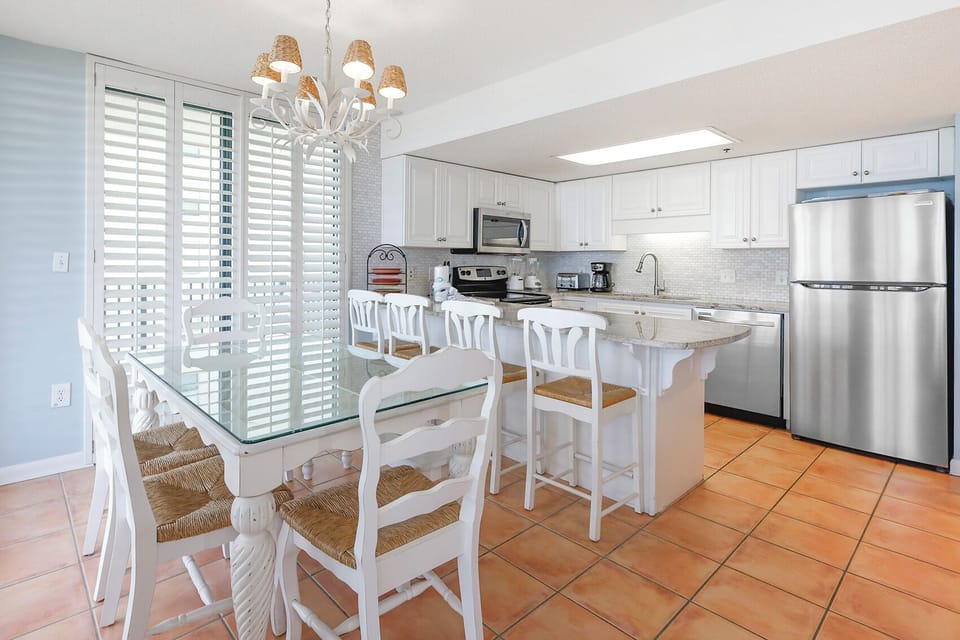 Enjoy meals in this inviting kitchen space, featuring stainless appliances and elegant design