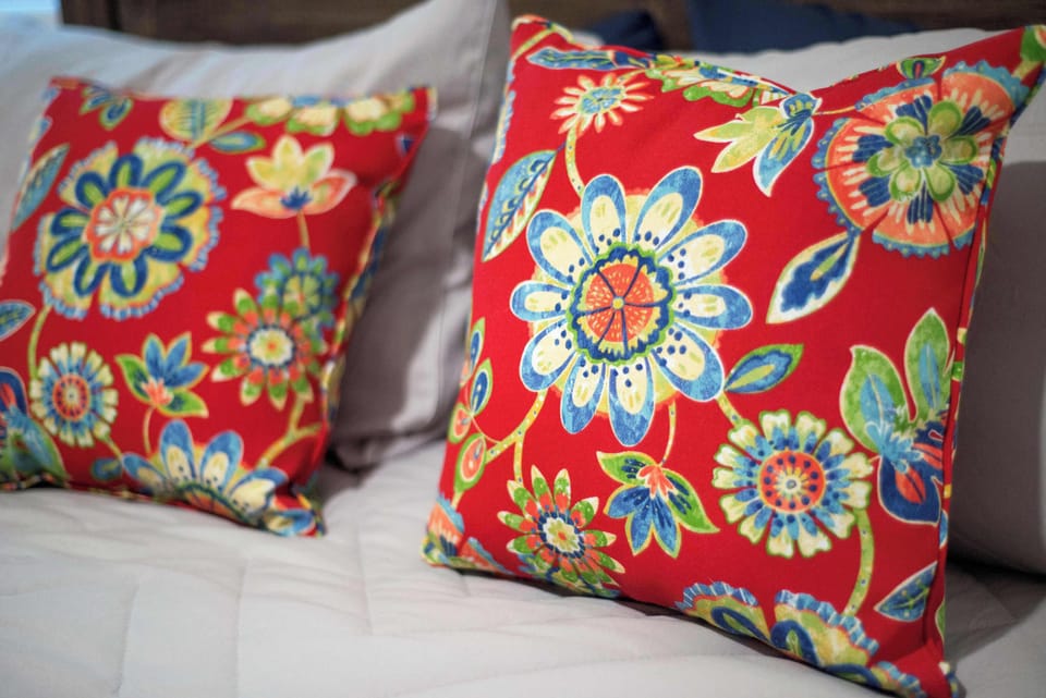 Brighten your stay with these vibrant floral pillows, adding a splash of color to your restful retreat.