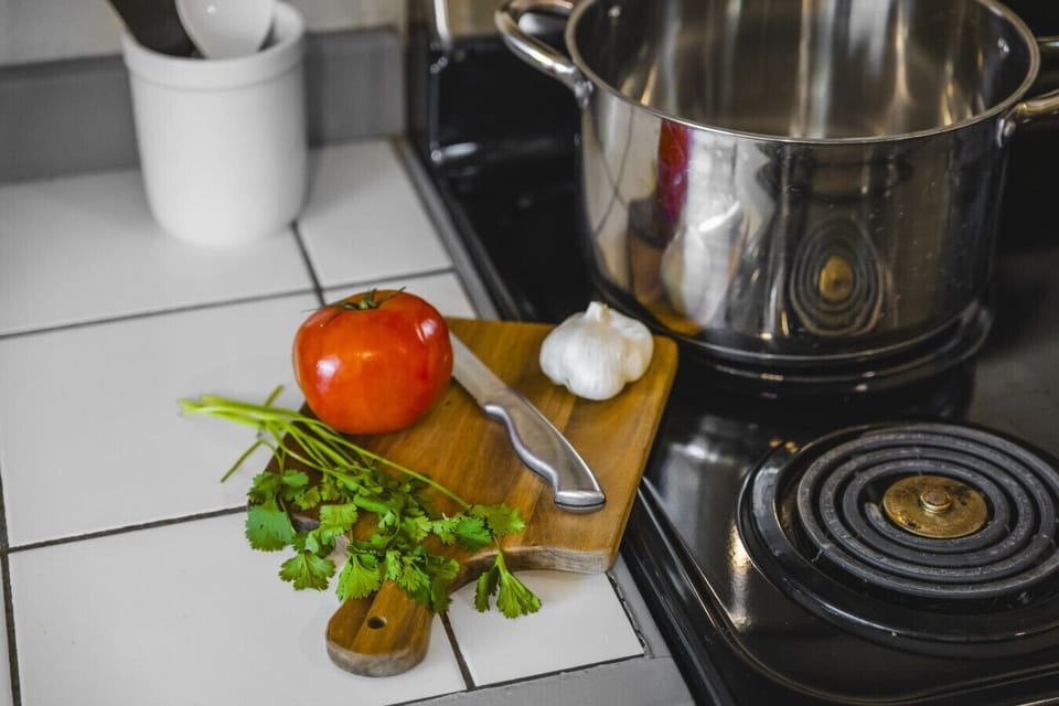 Chef`s Kitchen & Cooking Amenities: Prepare delicious home-cooked meals with ease in this fully equipped kitchen, featuring stainless steel cookware, a electric cooktop, clean tile countertops, and a wooden cutting board prep station stocked for your culi