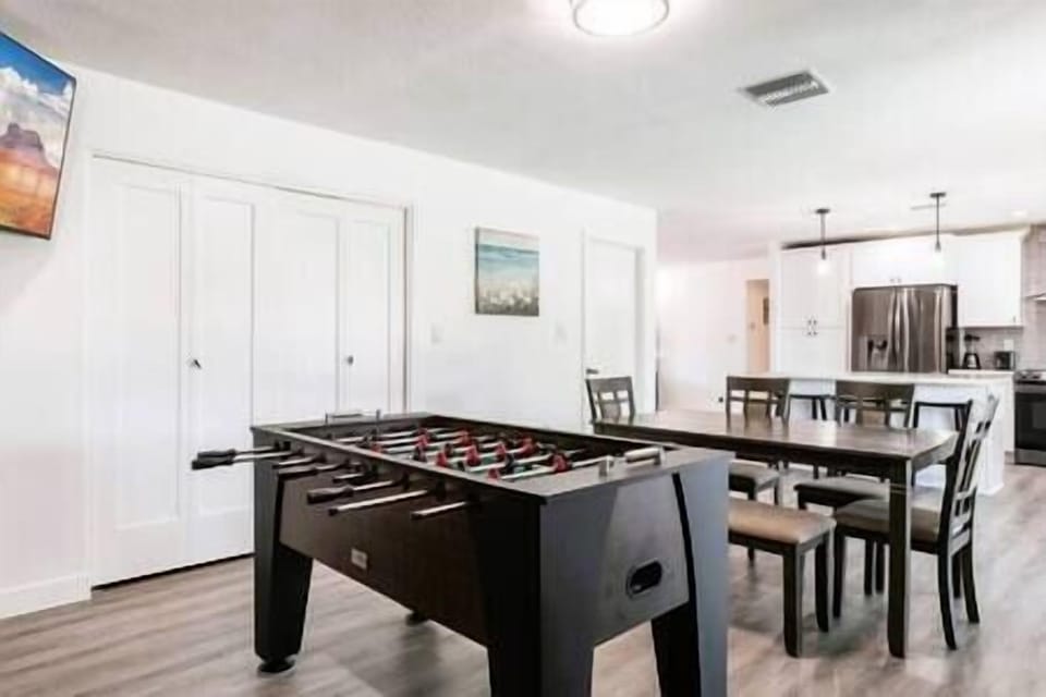 Dining room table sits six. Competition size Foosball table, laundry closet and 55 in smart TV. Open