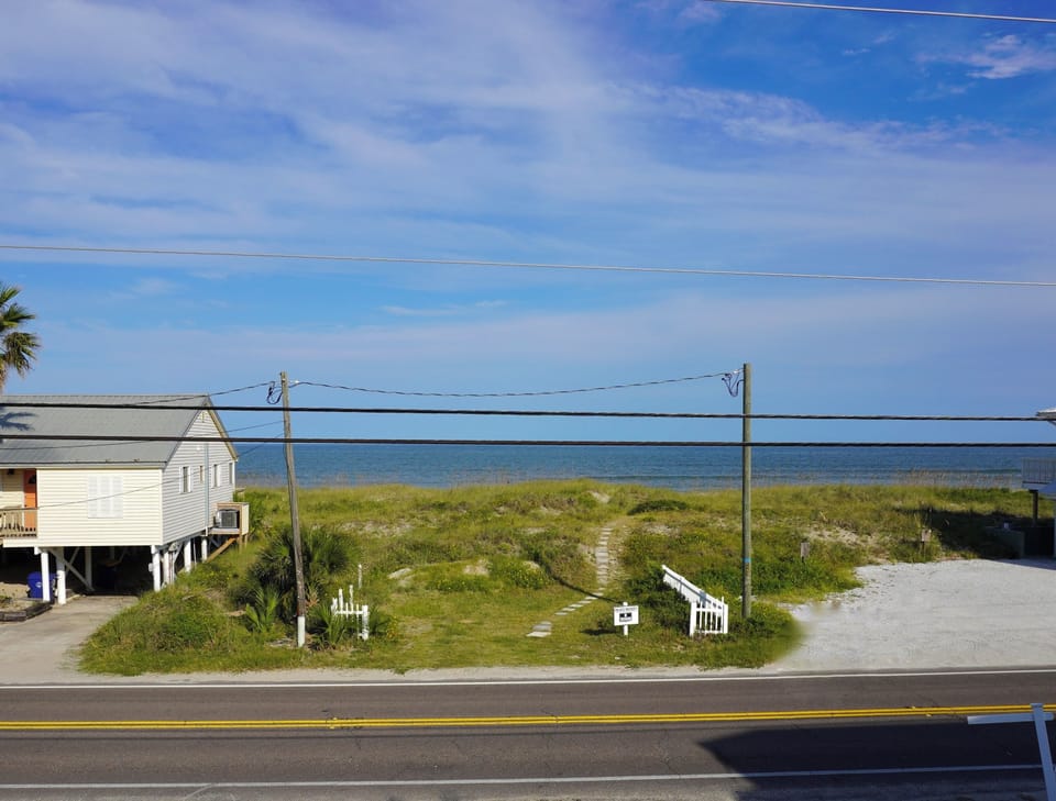 Enjoy ocean views from the upstairs deck at Sunshine’s Happy Place. From sunrise coffee to evening breezes, this spot gives you front-row access to coastal beauty—just steps from the beach and perfect for a peaceful pause any time of day.