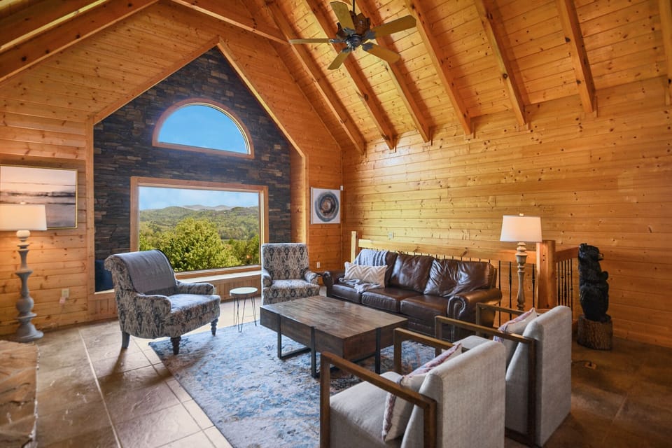Spacious open-concept living and dining area with vaulted wood ceilings in Smoky Mountains cabin.