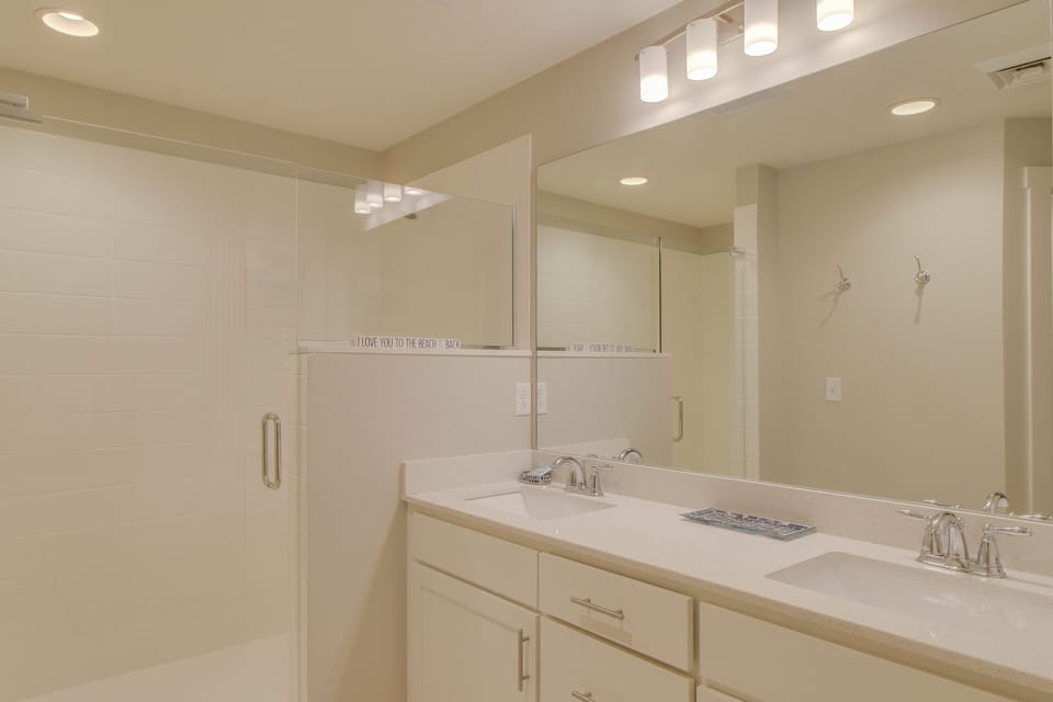 This awesome master bathroom features a double vanity + bright light in the bathroom + large mirrors!