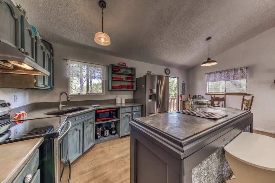 Large Open Kitchen with stainless steel appliances and island with dining table for the family