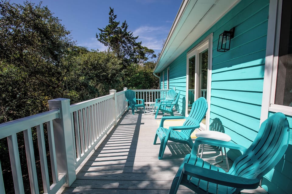 Large upper back deck nestled in trees. 