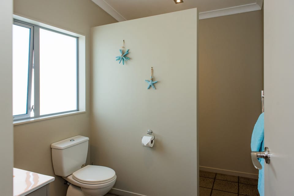 Main bathroom with shower, vanity & toilet. 
