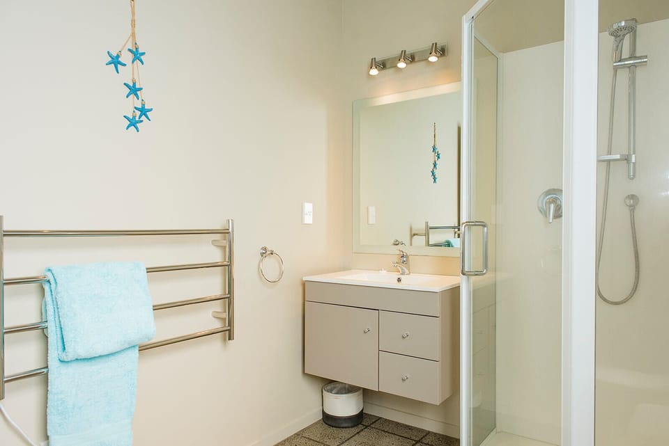 Master bedroom ensuite with vanity, heated towel rails, large shower & toilet. 